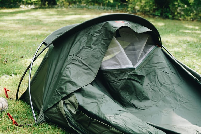 Alpkit Elan hooped bivvy with the outer zipped back to reveal the forward-facing mesh panel for airflow.