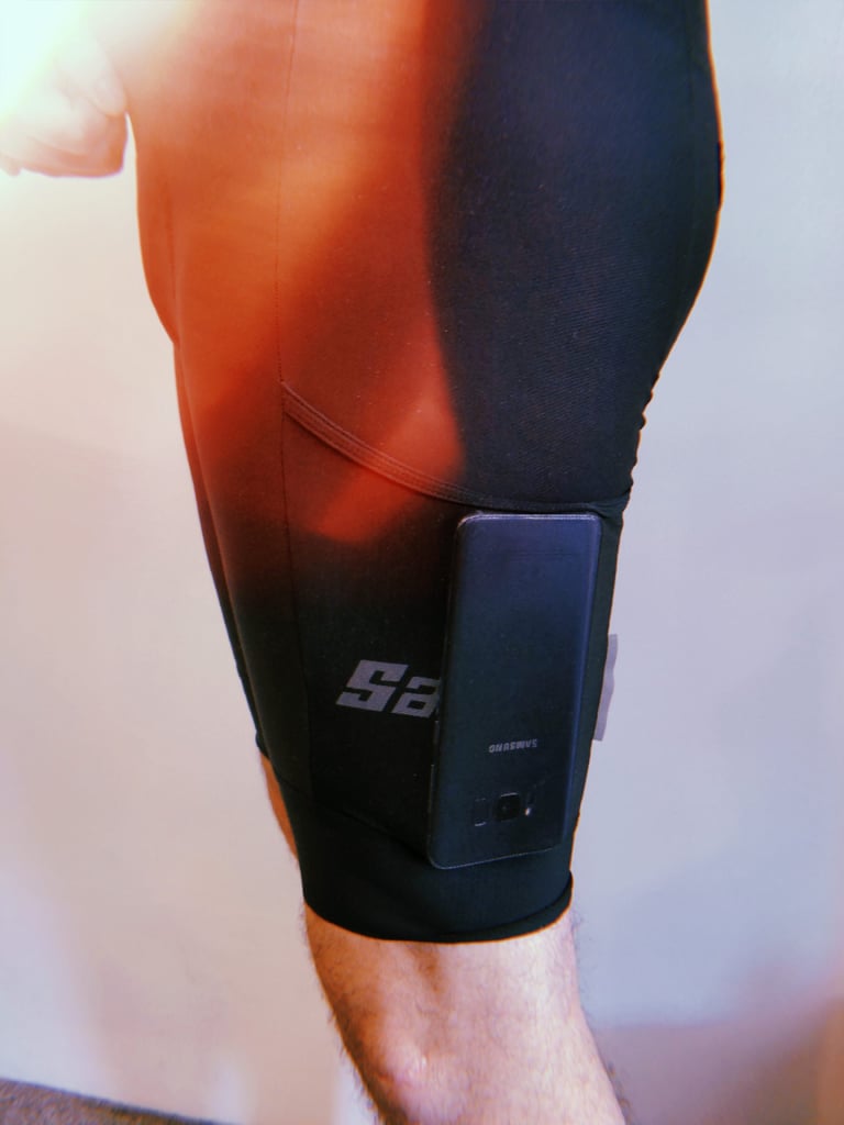Samsung S8 phone sitting in the side thigh pocket of the Santini Gravel Bib cargo shorts, seen from the side.