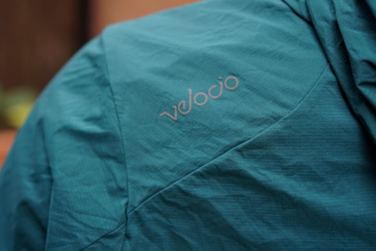 Reflective Velocio logo printed on the shoulder of the deep sea jacket.
