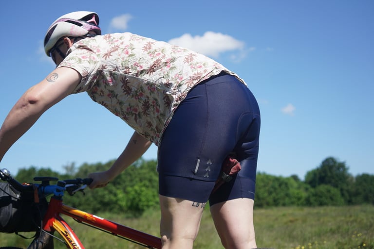 Rider leaning over a red flat-bar bike in Triban RC500 bib shorts, the thin fabric bunching around the hips.