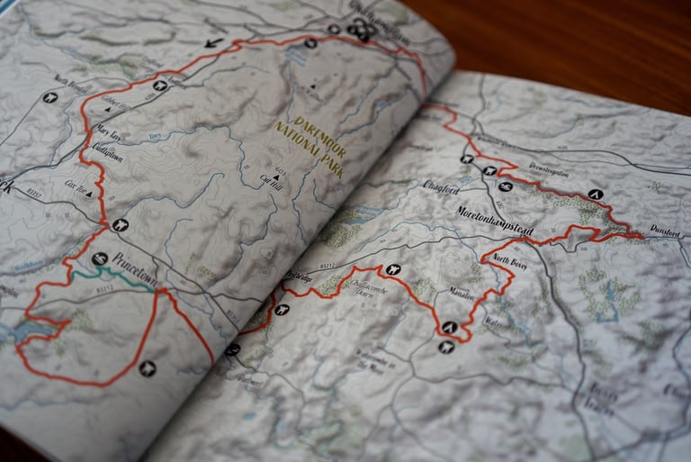 Double-page route map of Dartmoor National Park in the Bikepacking England guidebook, route marked in red.