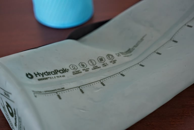 HydraPak Seeker 2L reservoir with volume markings and Filter Compatible icon printed on its side.