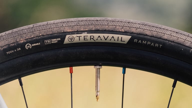Teravail Rampart 700c x 38 Durable tyre showing its slick centre and grooved shoulder tread, with a tubeless valve.