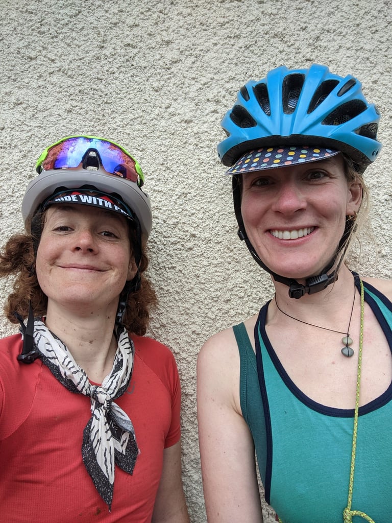 Adeline in the black-and-white Mystic Felines cotton neckerchief beside a smiling rider in a blue helmet.