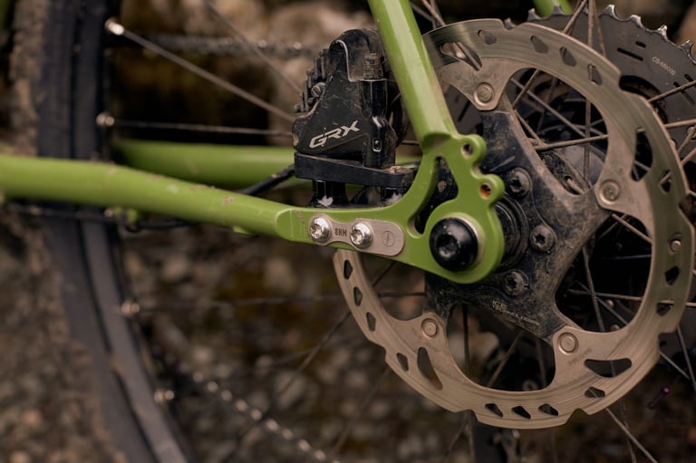 Muddy Fairlight Faran 2 rear dropout in green with Shimano GRX brake calliper, thru axle and disc rotor.
