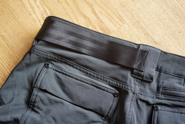 Black webbing strap across the rear waistband of the Chrome Anza shorts, which doubles as a lock holster.