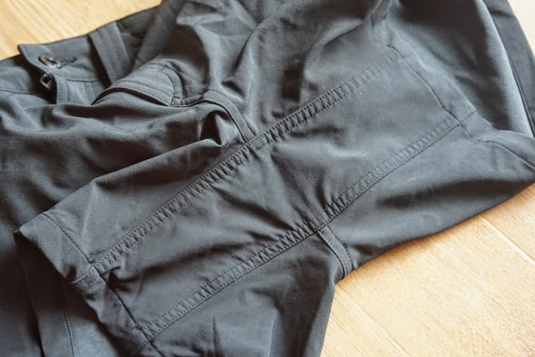 Close-up of the stitched double-layer gusset seams in the crotch of the black Chrome Anza shorts.