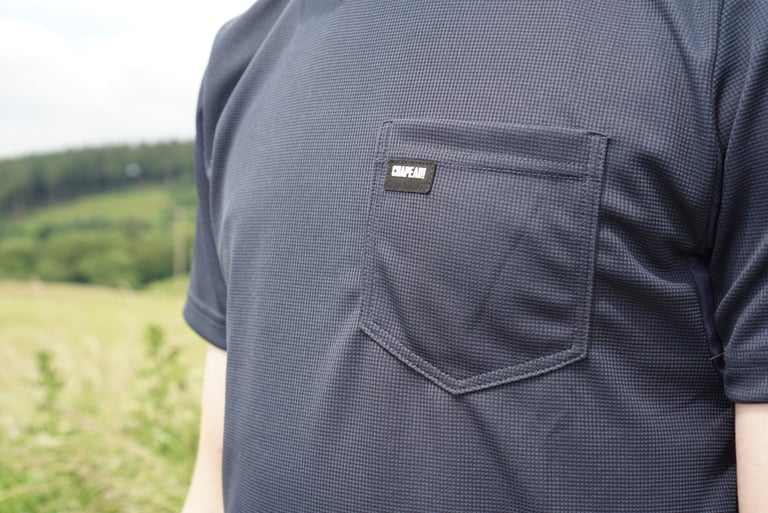Close-up of the small left-breast pocket and Chapeau! label on the Dry Tech Tee.