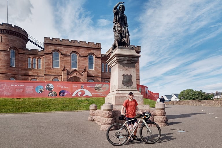 Marcus Nicolson with his Mason bike by the Flora MacDonald statue at Inverness Castle, start of the Badger Divide.