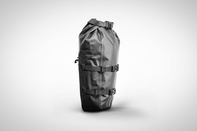 Tailfin 10L Mini Pannier in black, three-quarter view, with roll-top closure and two T-Hook compression straps.