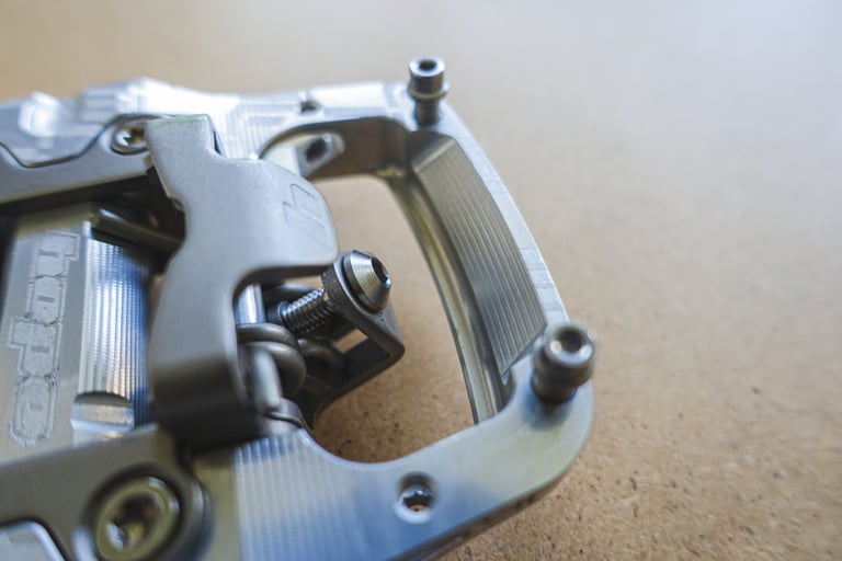 Close-up of the Hope Union Trail pedal's machined cage, cleat clip and two of its grip pins.