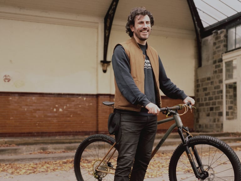 Rob Quirk stands with the Superchub, his lightweight steel XC mountain bike, at Bespoked 2021 in Harrogate.