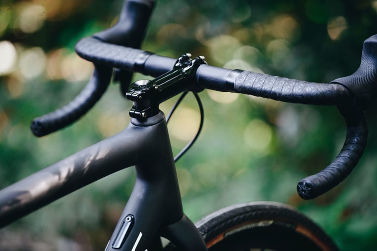 Specialized Crux cockpit with a two-piece stem and handlebar, wrapped in textured black tape.