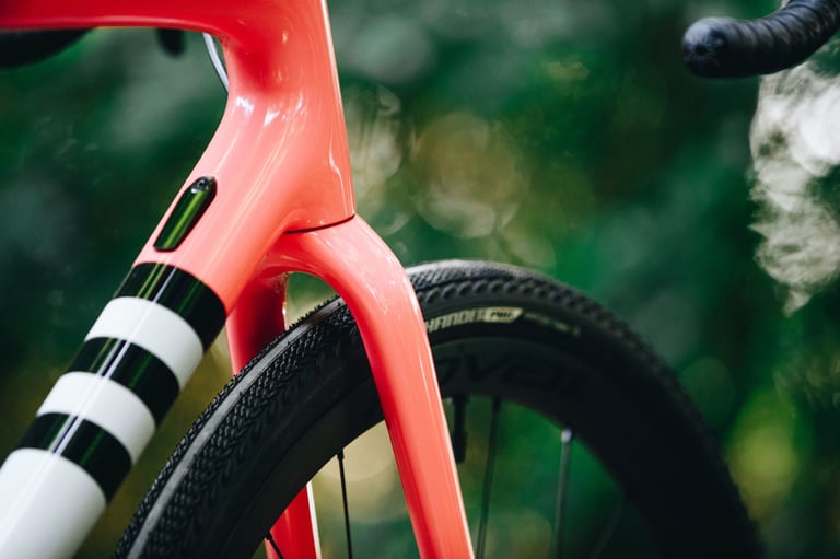 Red Specialized Crux head tube, fork crown and front tyre clearance, with black and white stripes on the down tube.