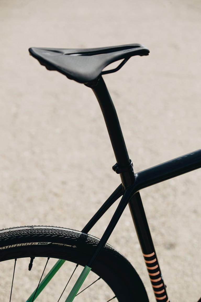 Specialized Crux saddle, seatpost and seat stay with copper stripes above a Pathfinder Pro rear tyre.