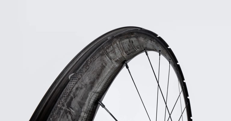Cutaway of a Scope carbon rim showing the extra layup around the spoke holes.