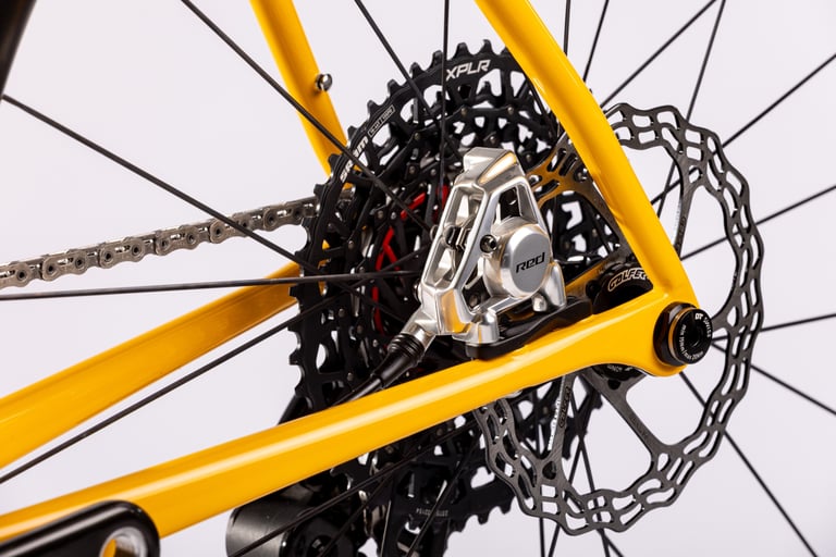 Close-up of the Repete G3: Verne's rear dropout with the UDH hanger, SRAM XPLR derailleur, flat-mount brake and rotor.